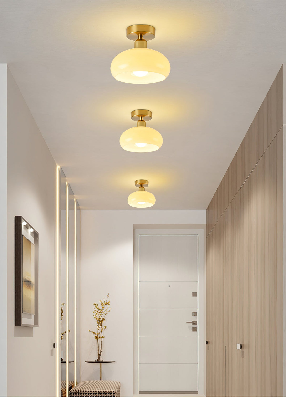 Three Clérachic ceiling lights in a row down a narrow hallway with wood-panelled walls and a door at the end.