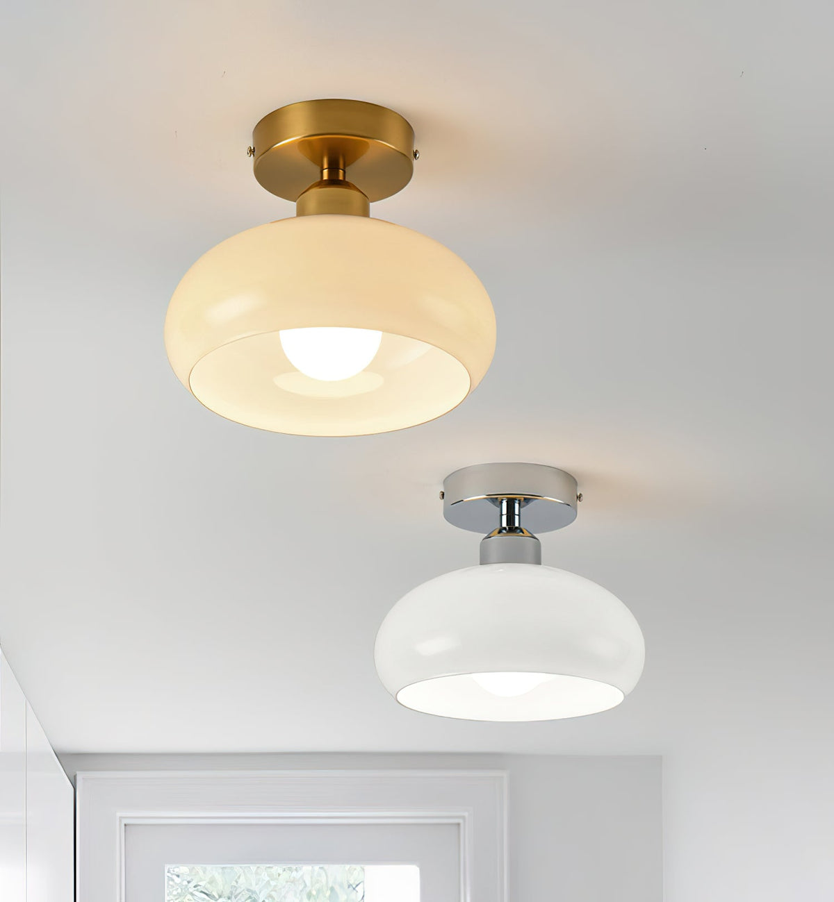 A beige glass Clérachic ceiling light with a brass canopy above a white glass one with a chrome canopy, shown side by side.