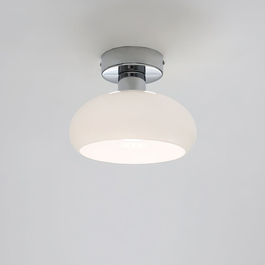 White glass dome with a chrome canopy and a bright inner rim, a Clérachic ceiling light on a pale grey backdrop.