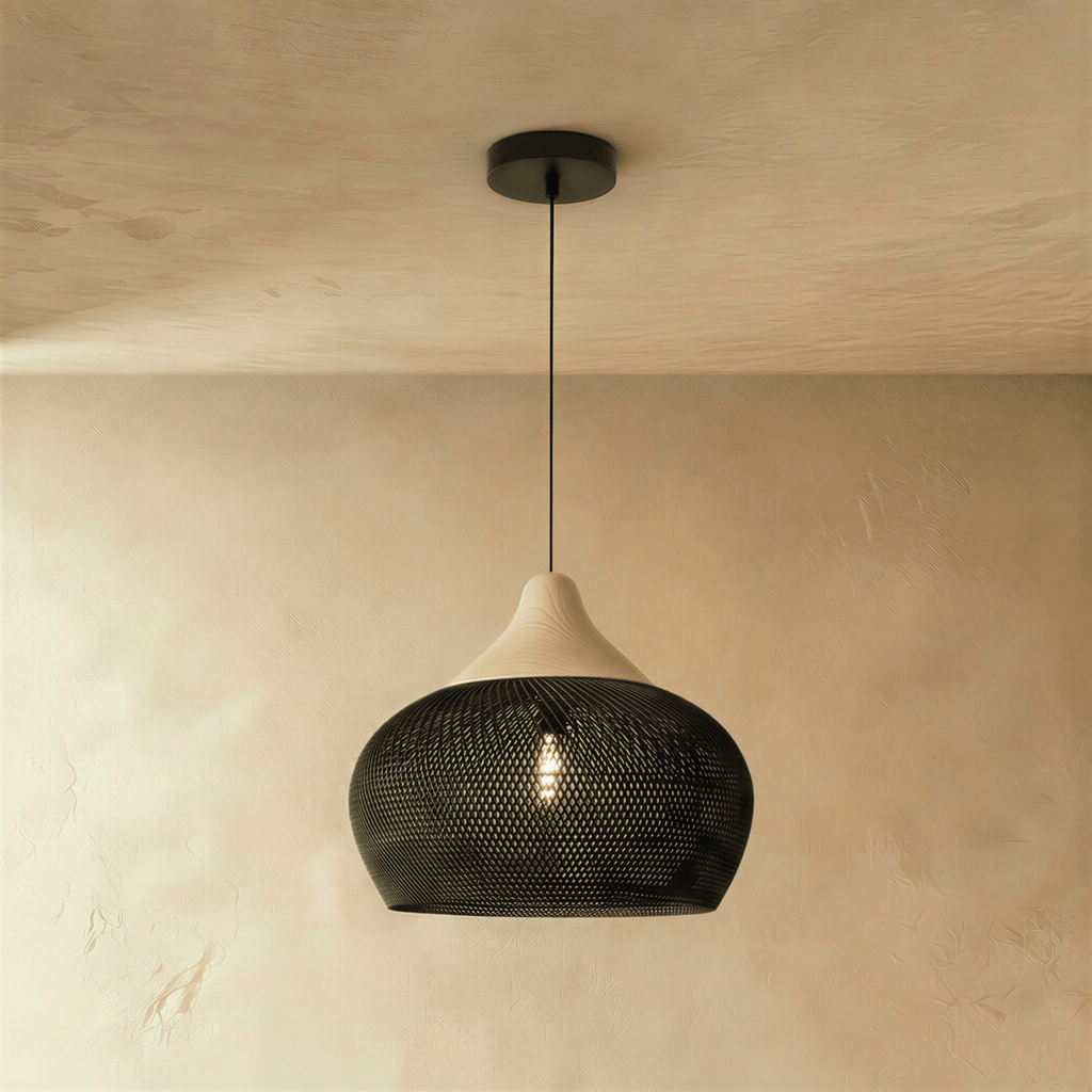 Clérachic black rattan pendant light with a broad woven bowl shade and beige wood cap over a plaster wall.
