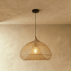 Clérachic natural rattan pendant light with a rounded beige dome shade and matching wood cap suspended from the ceiling.
