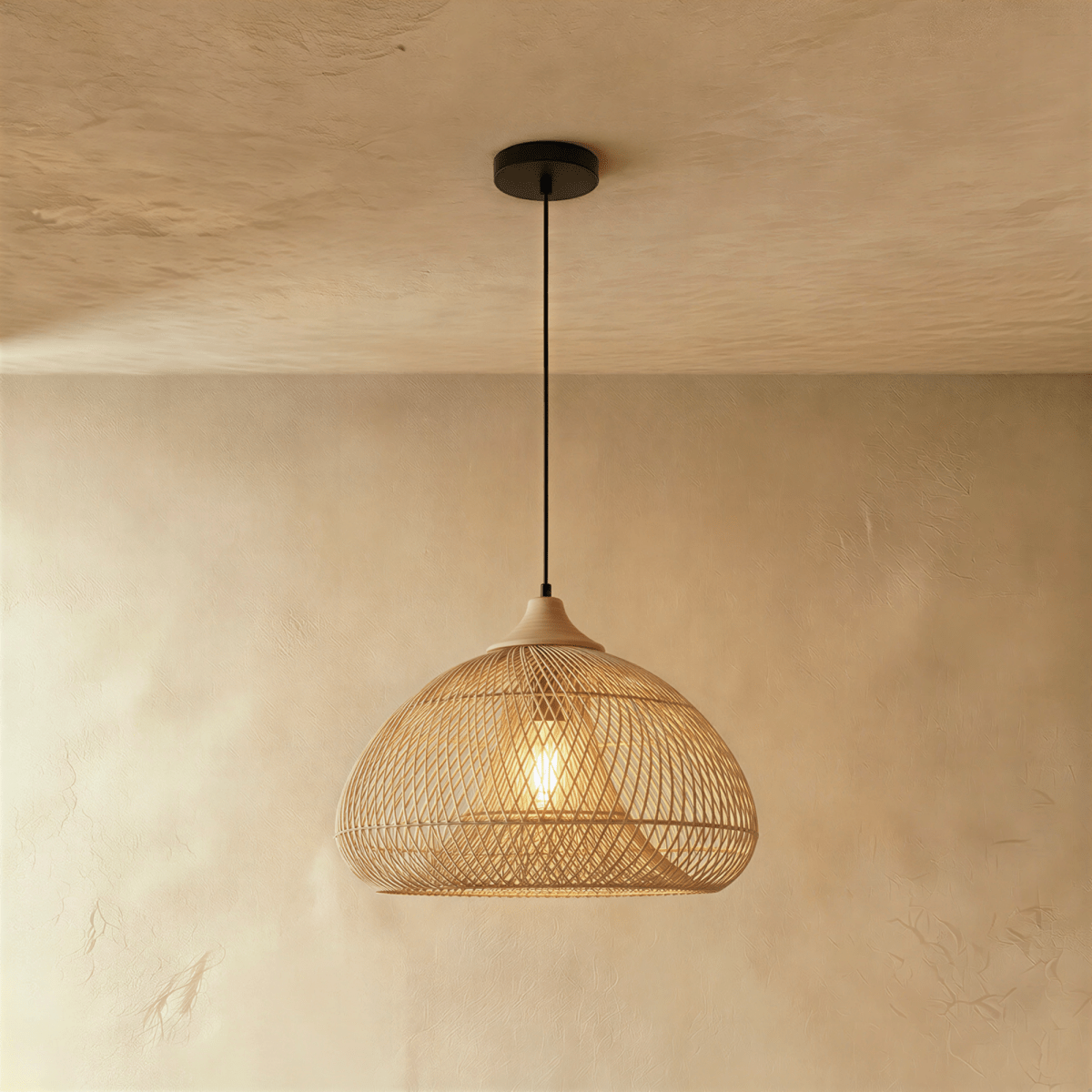 Clérachic natural rattan pendant light with a woven beige dome shade and wood cap glowing against a plaster wall.