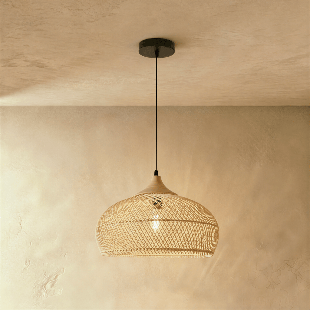 Clérachic natural rattan pendant light with a beige woven dome shade and wood cap hanging over a plaster interior.