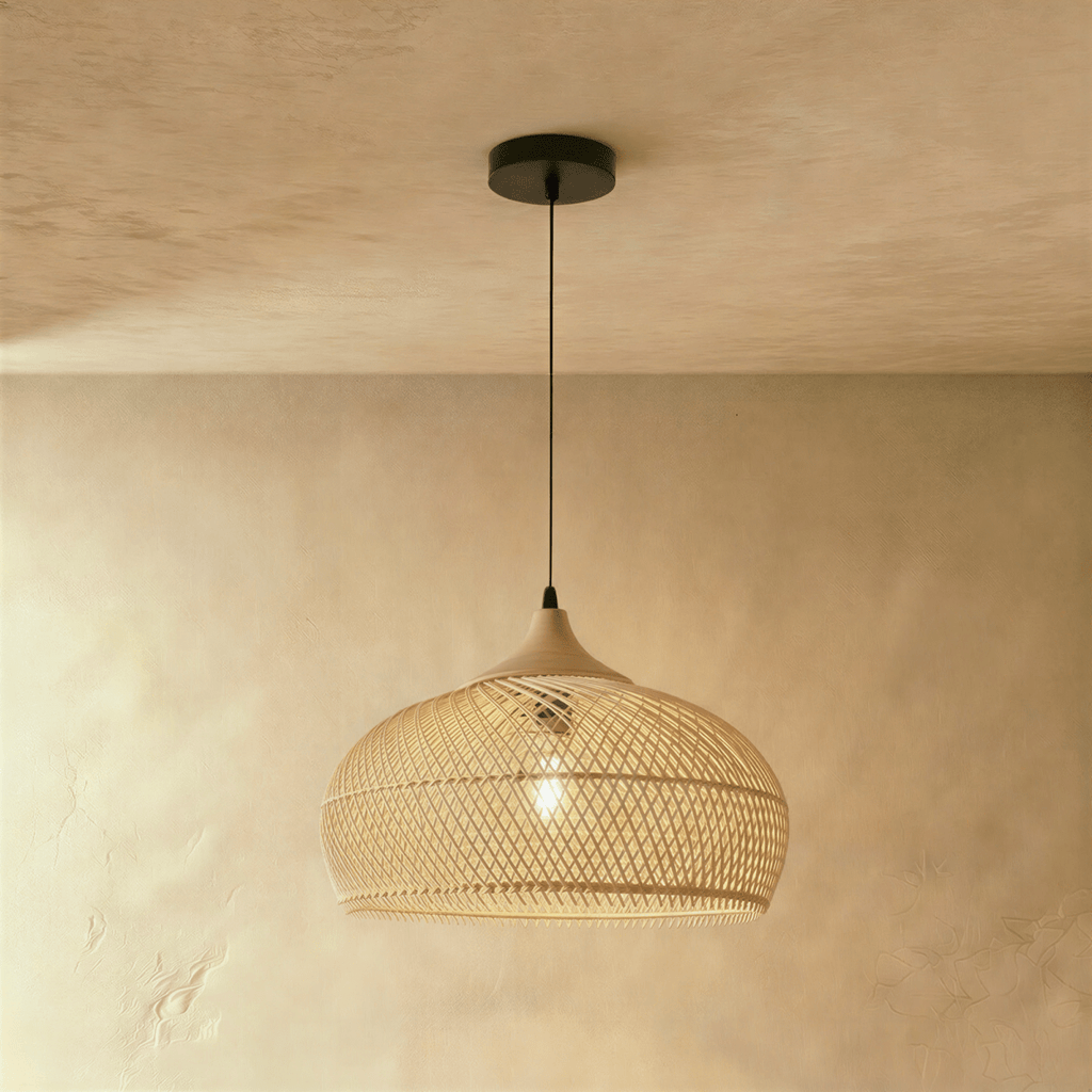 Clérachic natural rattan pendant light with a rounded beige dome shade and wood cap against a warm plaster wall.