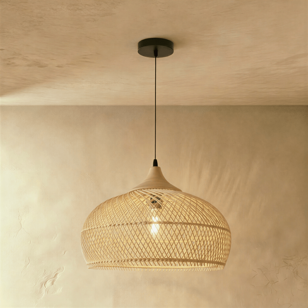 Clérachic natural rattan pendant light with a woven beige dome shade and matching wood cap, lit near a plaster wall.