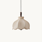 Beige pleated fabric Clérachic pendant with a scalloped petal shade and walnut-coloured beads, on a plain white backdrop.