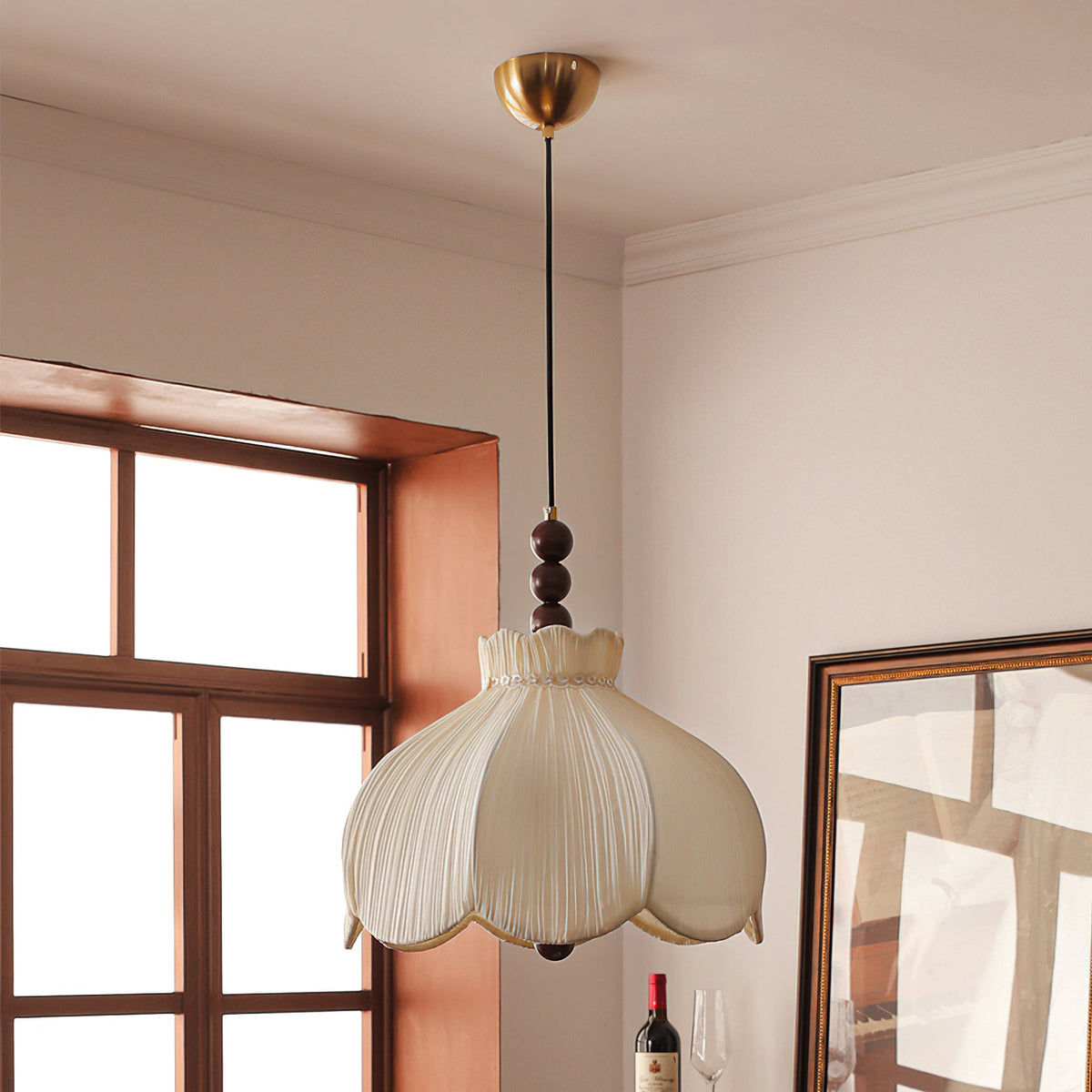 Clérachic petal-shaped pendant on a brass canopy and thin cord, hanging near a window and a framed mirror.