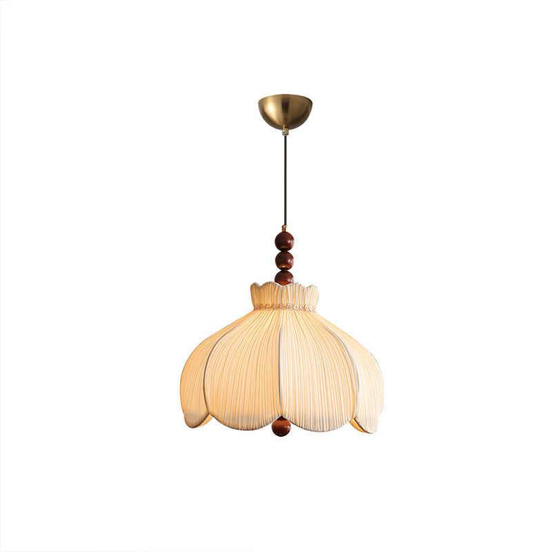 Beige pleated Clérachic pendant with a brass canopy, walnut beads and a thin cord, on a white background.