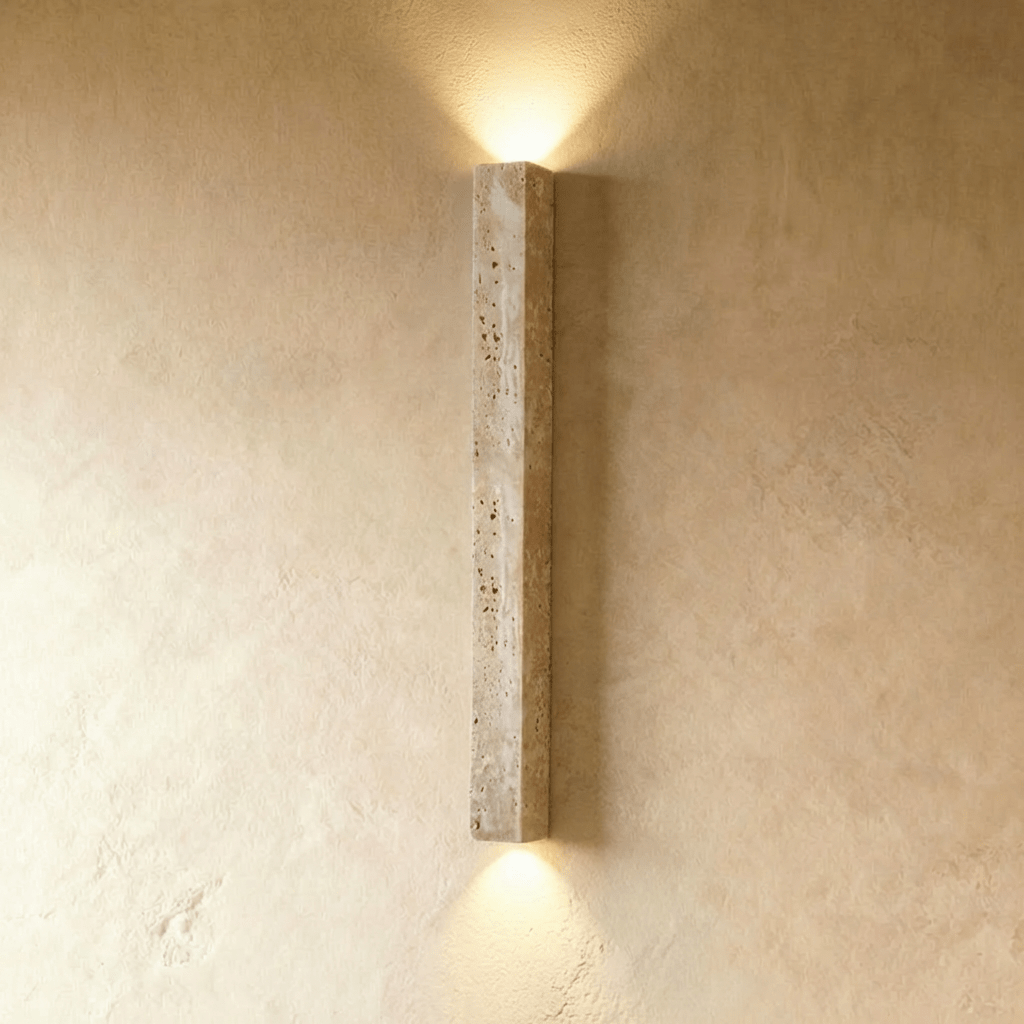 Clérachic slim square travertine wall light without a globe, casting soft light up and down a limewash wall.