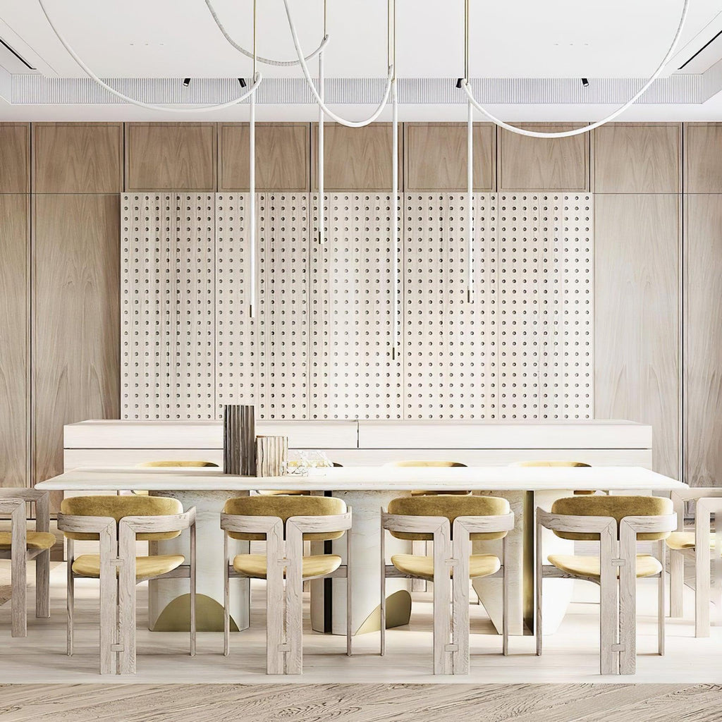 Pale Clérachic rope pendants hanging over a long white table with gold-cushioned chairs, in front of a perforated wooden wall.