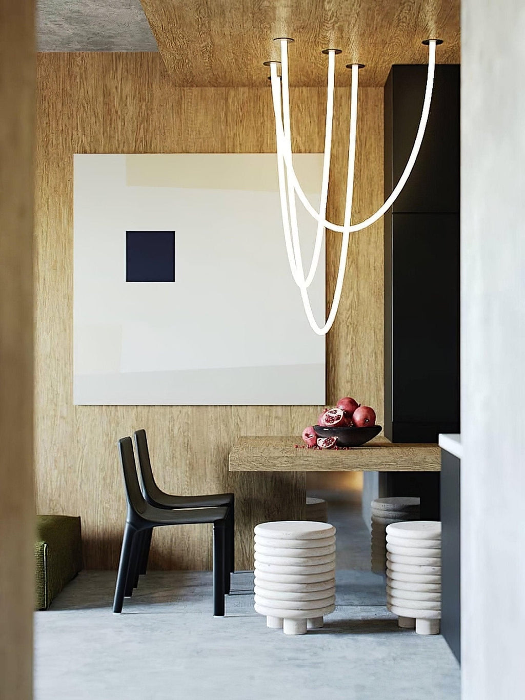 Clérachic LED rope pendants dropping from a ceiling in a warm, wood-clad corner with a dark bar counter and a framed artwork.