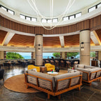 Clérachic LED rope pendants forming wide loops under a round dome, above a lounge with wood-framed sofas and a circular rug.