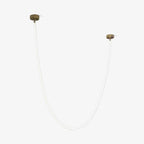 This Clérachic LED rope pendant on a pale backdrop, unlit, a thin white tube looped between two gold-toned ceiling plates.