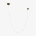 This Clérachic LED rope pendant on a pale grey backdrop, unlit, a thin tube in a wide U between two gold-toned plates.