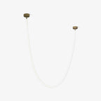 A shorter Clérachic LED rope pendant on a pale backdrop, unlit, with two gold-toned plates at different heights.