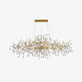 Clérachic Bijou chandelier on white, clear glass drops hung along a slender gold branch frame.
