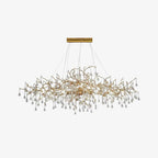 Clérachic Bijou chandelier on white, clear glass drops hung along a slender gold branch frame.