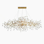 The Clérachic Bijou chandelier fuller on white, glass teardrops massed beneath the gold branches.