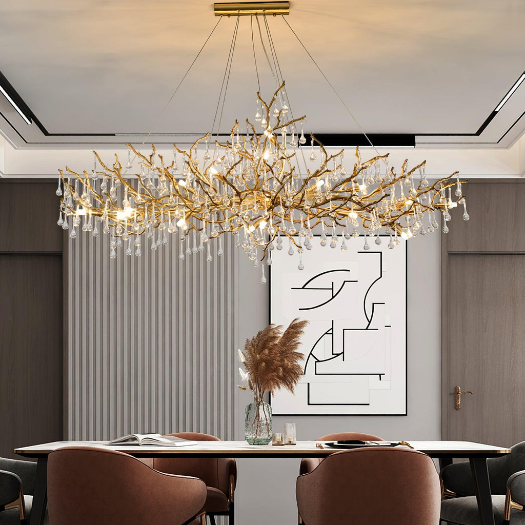 Clérachic Bijou chandelier lit above a dining table, fluted wall panel and framed art behind.