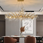 Clérachic Bijou chandelier lit above a dining table, fluted wall panel and framed art behind.