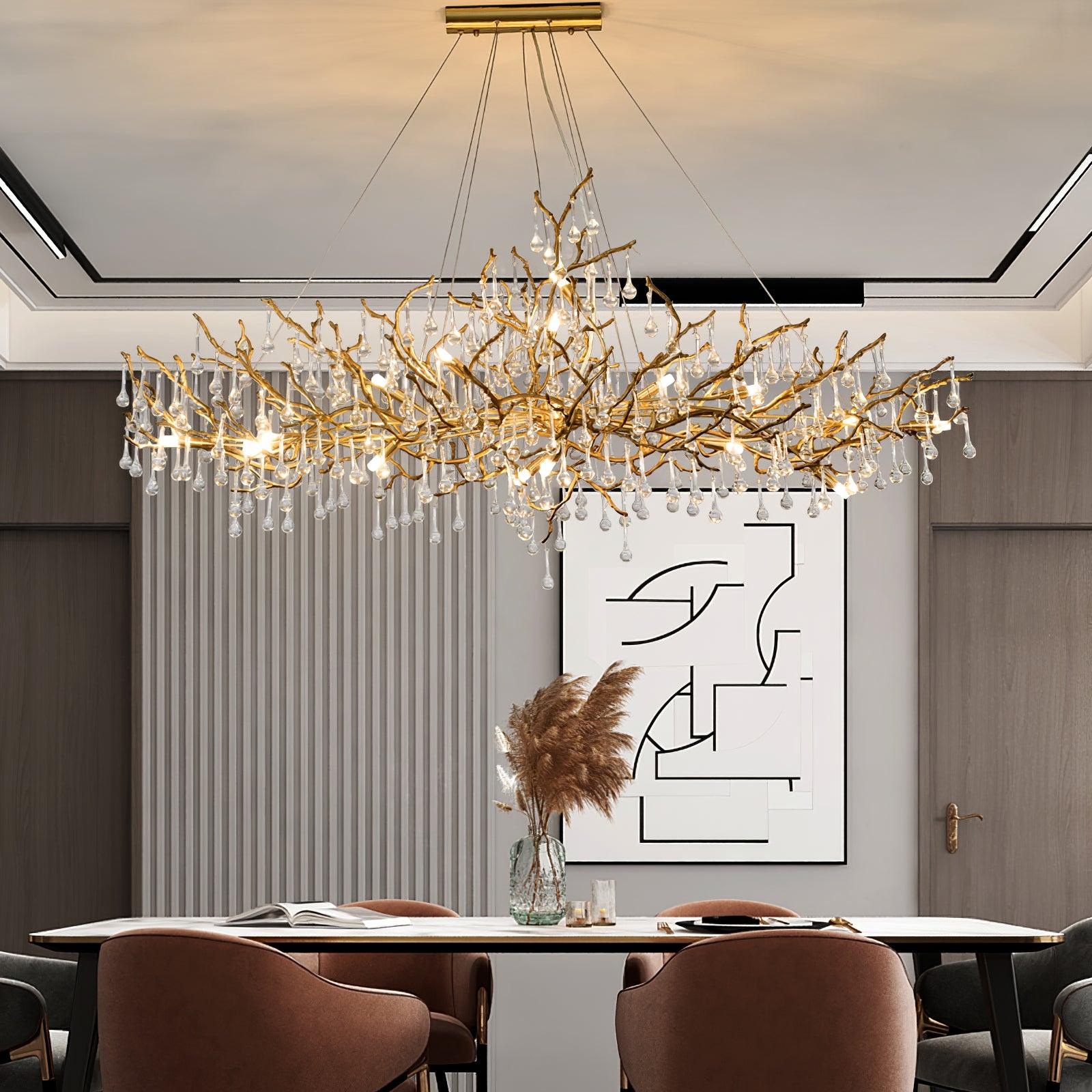 Clérachic Bijou chandelier lit above a dining table, fluted wall panel and framed art behind.
