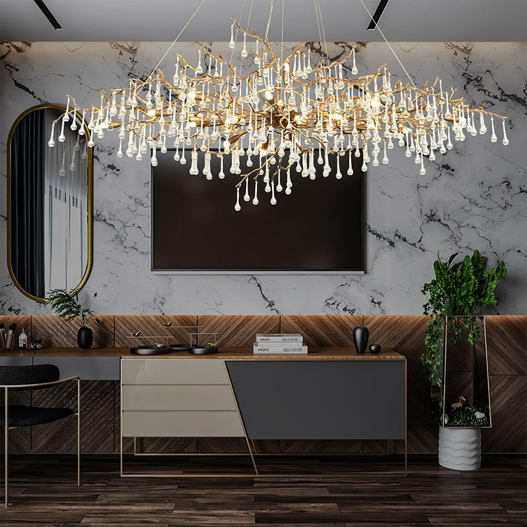 The Clérachic Bijou chandelier lit above a desk in a marble-walled room with a television.