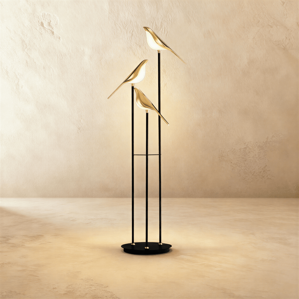 Clérachic three-head bird floor lamp, 153 cm tall, with gold-finish bird shades glowing warm white on slim black stems