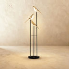 Clérachic three-head bird floor lamp, 153 cm tall, with gold-finish bird shades glowing warm white on slim black stems