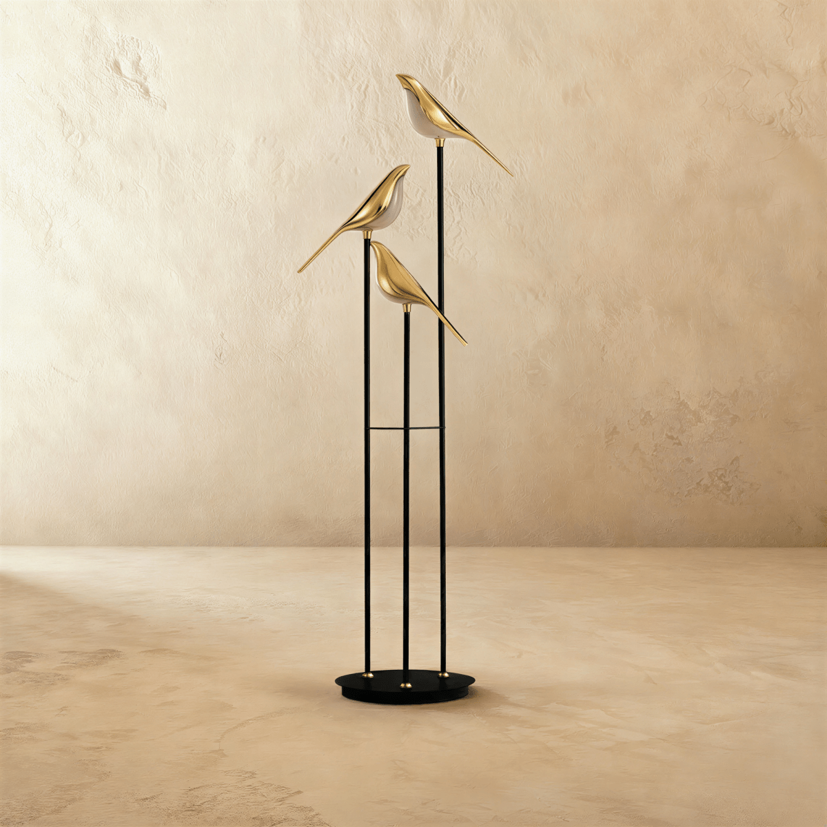 Clérachic three-head floor lamp with gold-finish bird shades on black stems and a round base, switched off on a limewashed floor