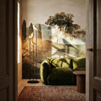 Clérachic three-head bird floor lamp beside a green velvet sofa, in front of a landscape mural