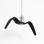 Clérachic gloss black gull-winged resin pendant on a braided steel cord, with a brushed aluminium cylinder, on a white ground.