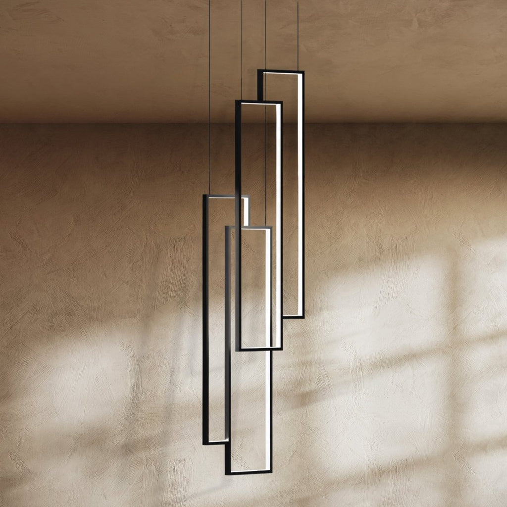 Clérachic black rectangular LED frames, four in a staggered stack, seen close up against a warm textured wall.