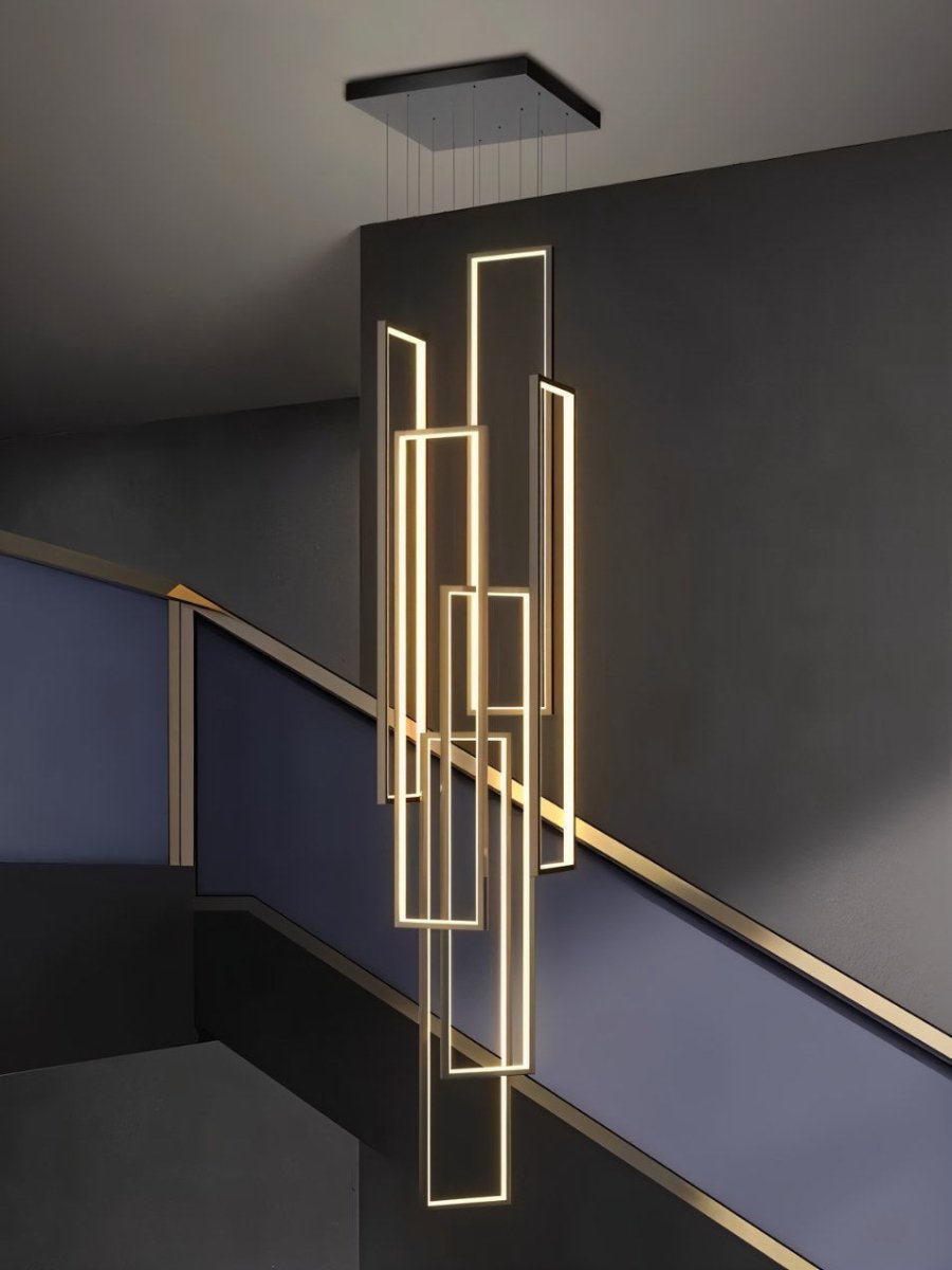 Clérachic black stairwell chandelier with six glowing LED frames hung from a square canopy beside a dark staircase rail.