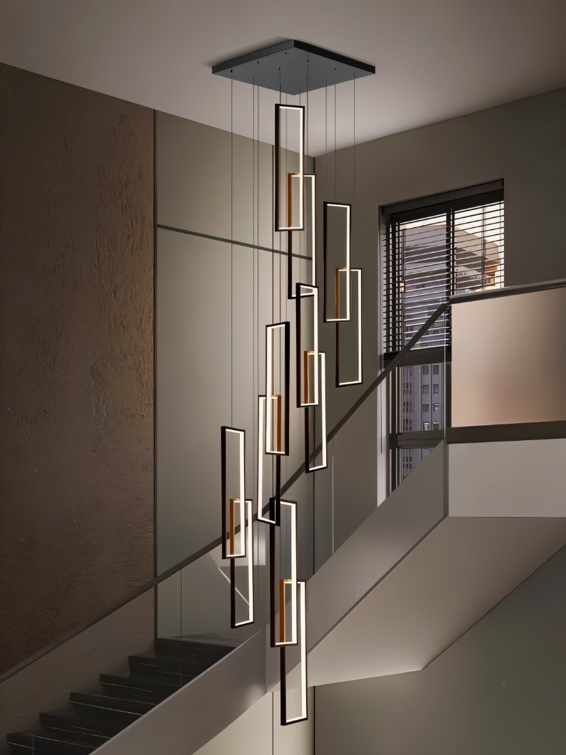 Clérachic black LED frame chandelier of many staggered rectangles with warm inner accents, hung in a stairwell by a window.