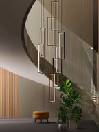 Clérachic black rectangular LED frames at staggered heights, hung in a curved stairwell beside a pot of green plants.
