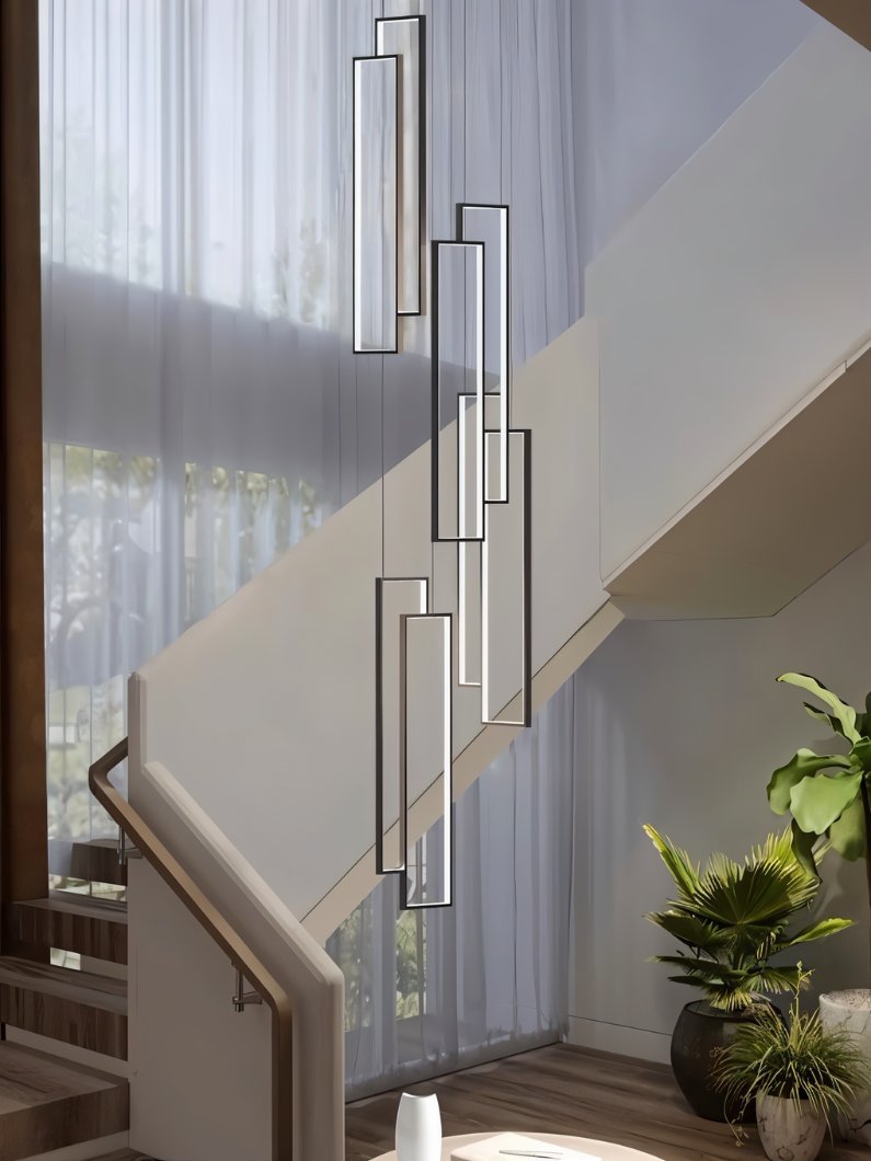 Clérachic black and white rectangular LED frames at staggered heights, hung beside a staircase with sheer curtains behind.