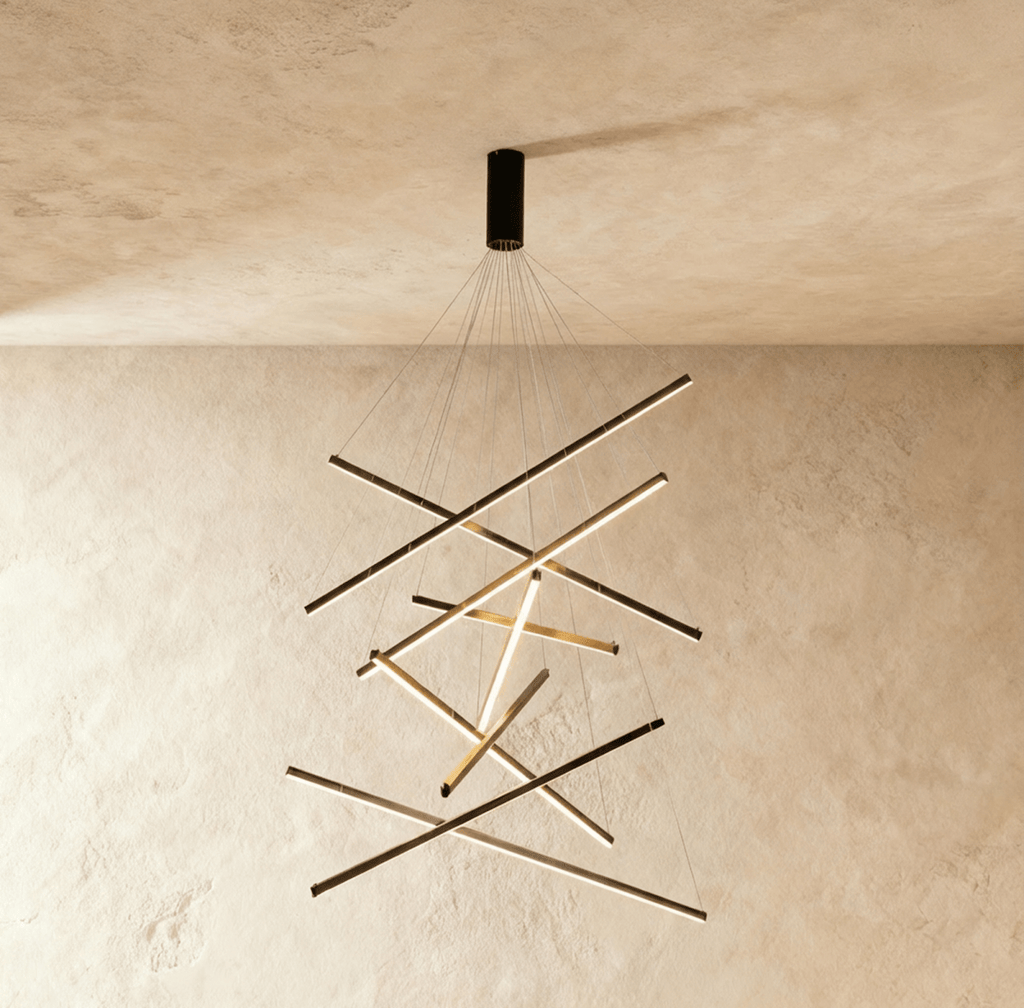 The Clérachic black chandelier's full nine-bar configuration, aluminium arms glowing warm white in a staggered cluster overhead.
