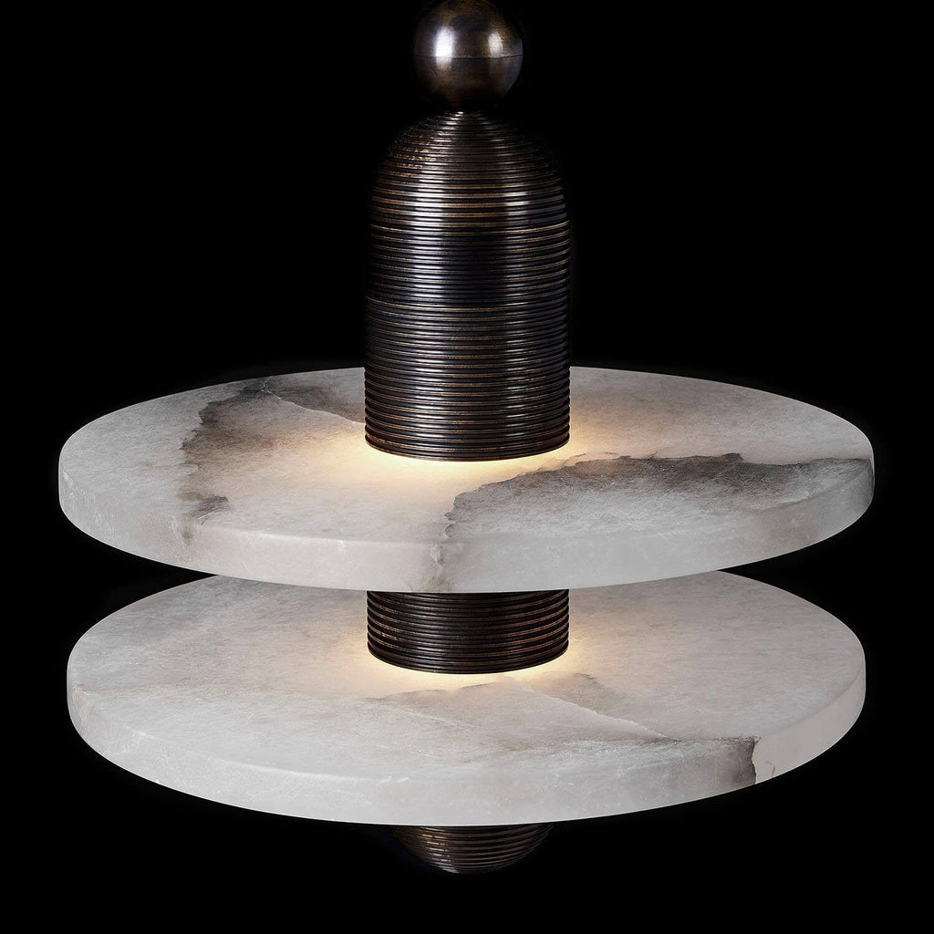 Clérachic black double-disc pendant in close-up, warm LED at each alabaster plate against a dark ground.