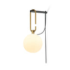 A Clérachic globe wall lamp glowing warm cream on a plain white background, its black cord running down beside it.