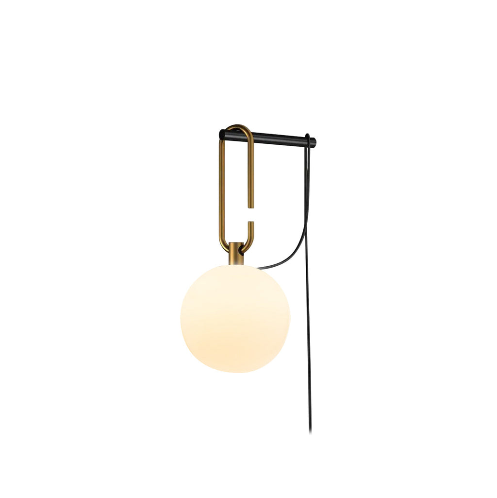 A Clérachic wall lamp with a warm cream globe on a gold loop and black bar, with its black cord, on a white background.