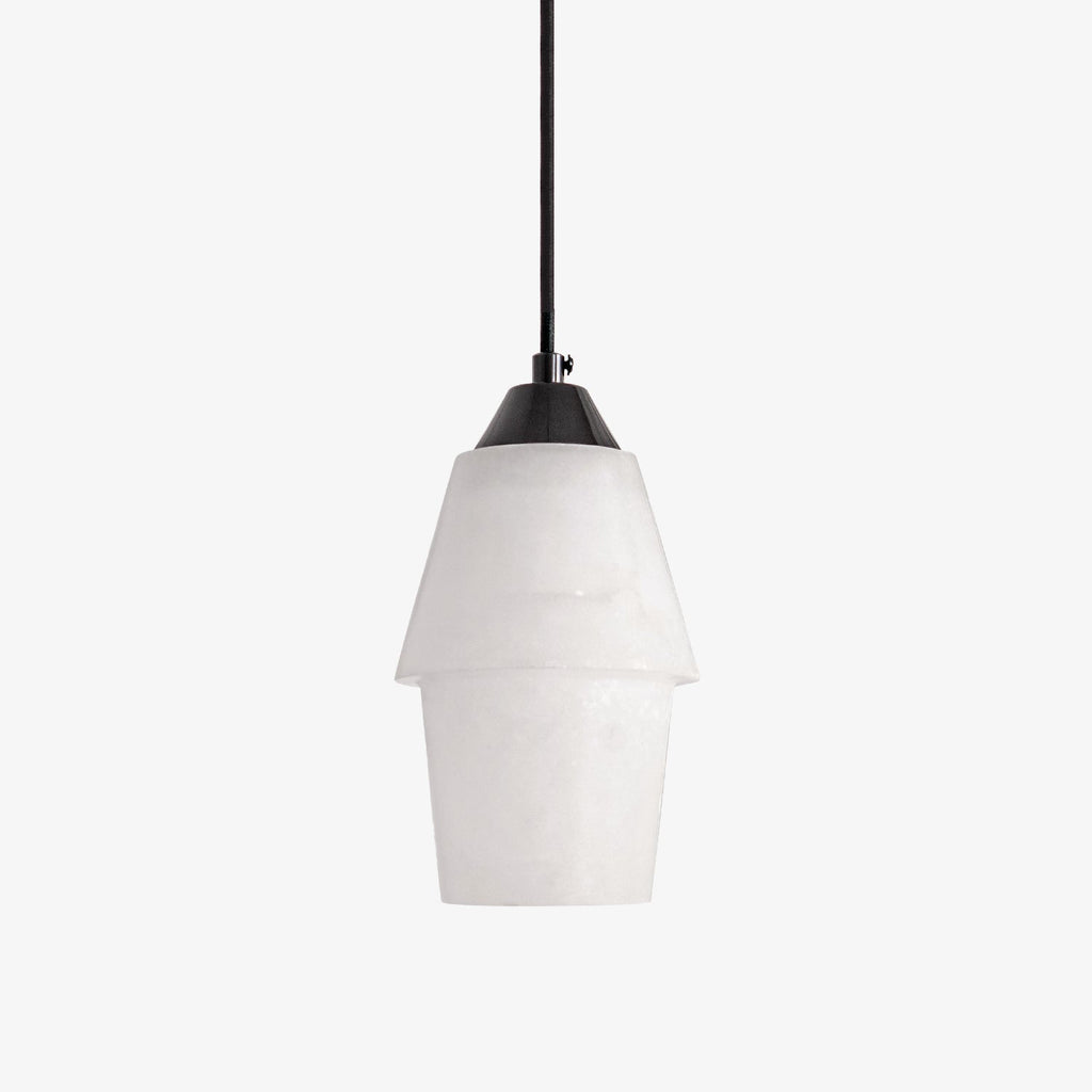 Clérachic Ostara Black and White Alabaster Pendant Light in studio, two-tier white cone and black cap on grey.