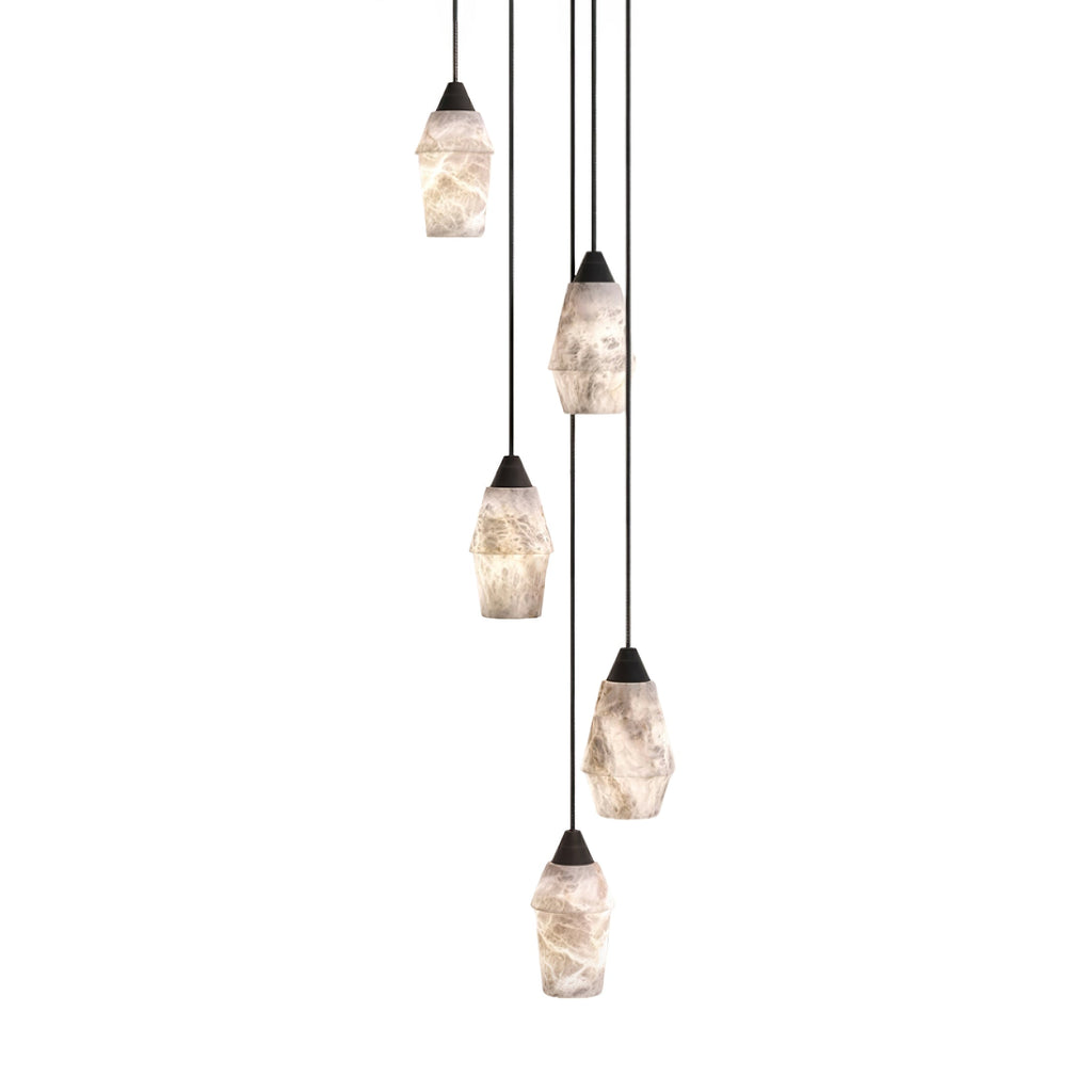 Five Clérachic Black and White Alabaster Pendant Lights cascade at staggered heights on black cords against white.