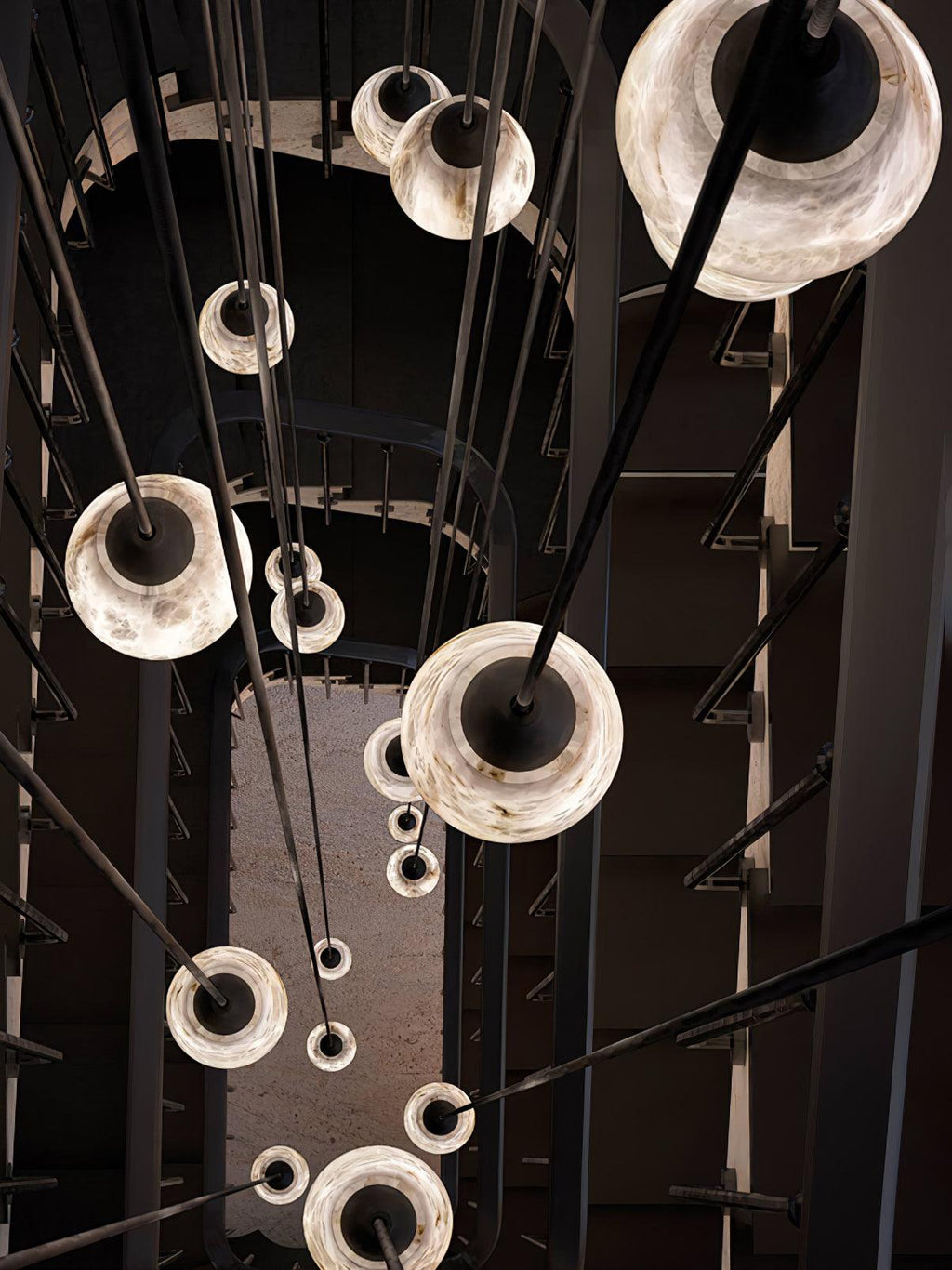 Clérachic Black and White Alabaster Pendant Lights glow down a dark stair hall, rounded white shades on long black stems.