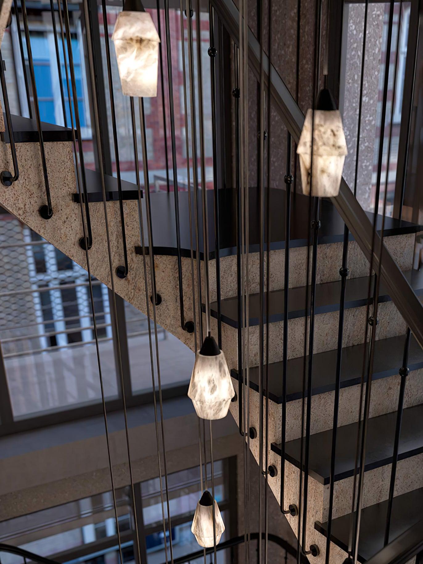 Clérachic Black and White Alabaster Pendant Lights line a stone stair, city windows and brick facades beyond the void.