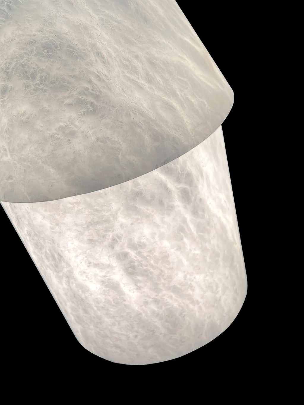 Close-up of the Clérachic Black and White Alabaster Pendant Light, cloudy veining where the upper dome overlaps the shade.