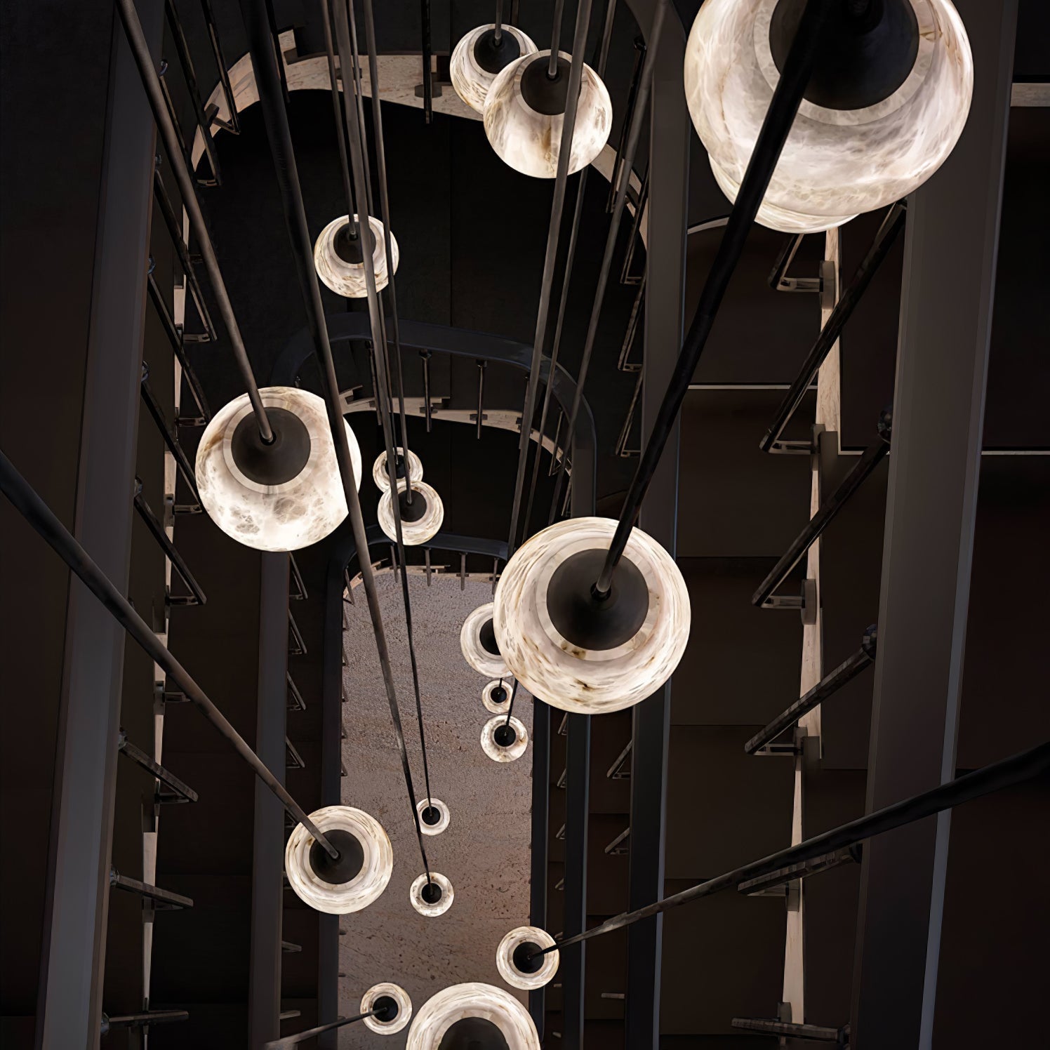 Clérachic Black and White Alabaster Pendant Lights recede toward the floor of an industrial stairwell on long black rods.