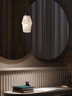 Clérachic Black and White Alabaster Pendant Light glows before paired round mirrors and ribbed wainscoting at a desk.