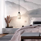 Clérachic Black and White Alabaster Pendant Light hangs in a mountain-mural bedroom with a marble plinth, pampas grass, and a pink duvet.