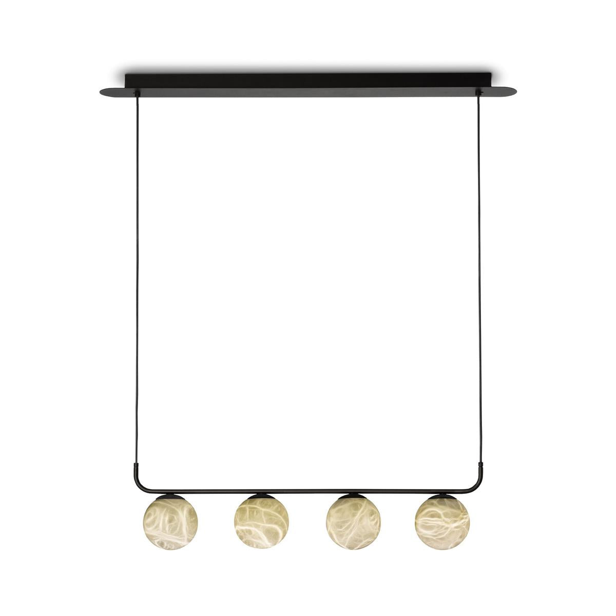 The four-globe Clérachic bar pendant lit on a white ground, its oval ceiling plate and two slim cables carrying the bar.
