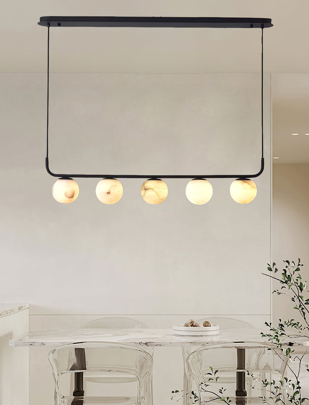 The Clérachic pendant hung from its oval ceiling plate in a bright room, five globes over a marble table.